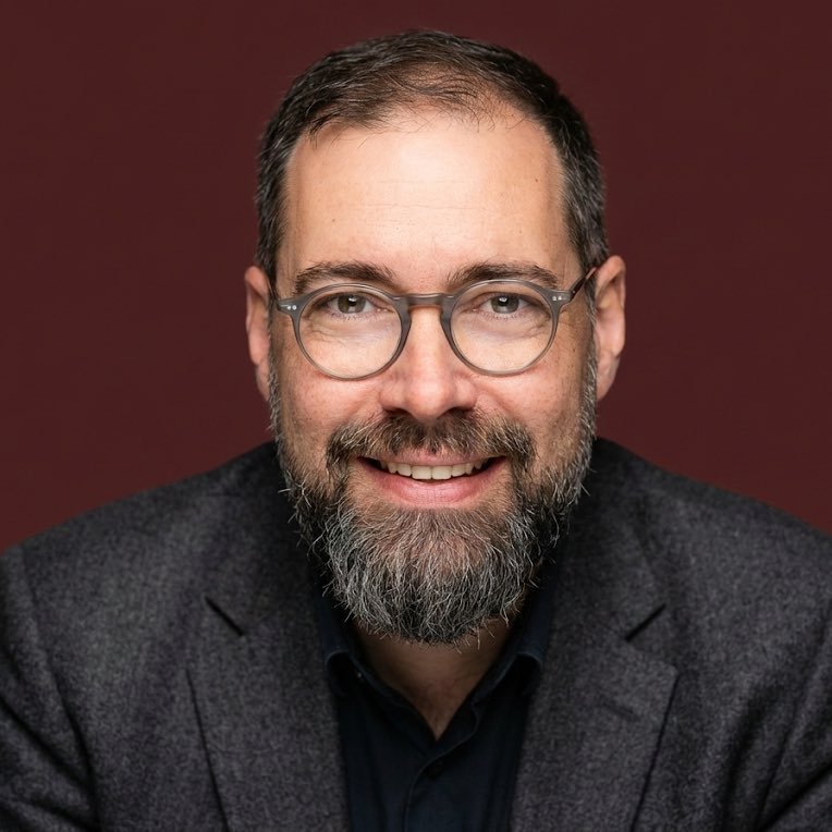 Professional Portrait of Smiling Man with Beard & Glasses Nano Banana提示词