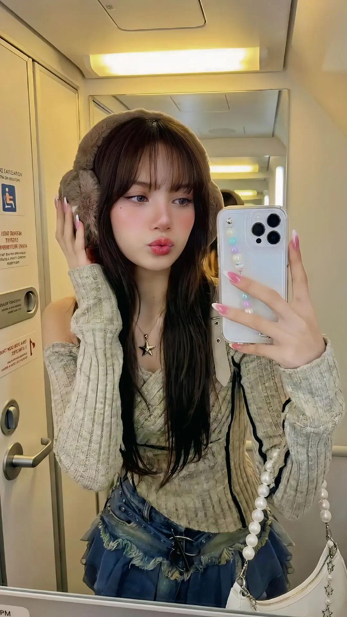 Stylish Young Woman Selfie with Earmuffs on Airplane Nano Banana提示词